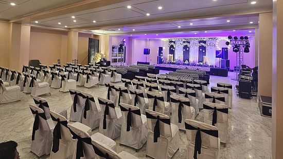 Image showcasing the spacious ballroom with rows of chairs, ideal for conferences and seminars.